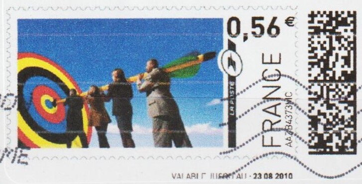 Four collegues carrying a dart unto a target