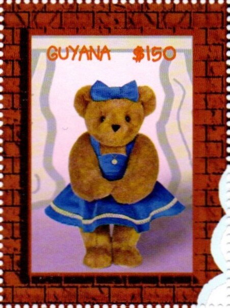 Bear dressed in blue dress and ribbon