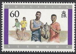 Boys holding sports trophy