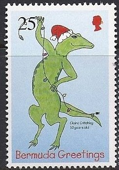 Lizard in Santa hat stringing Christmas lights