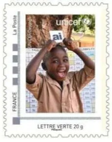 Unicef Boy holding an "ai" flash card