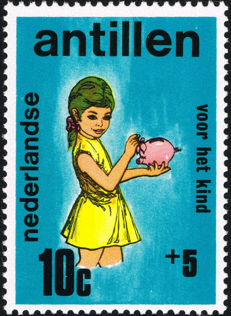 Girl holding piggy bank.