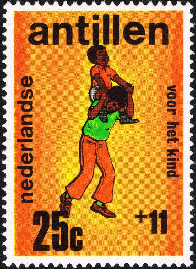 Youth carrying small boy on his shoulders