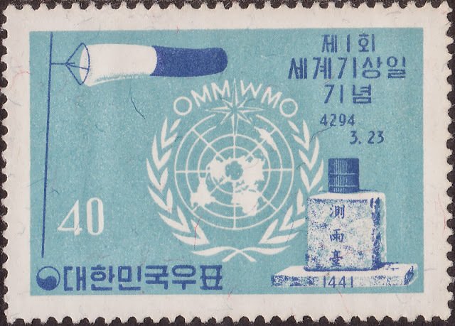 UN emblem and ancient rain gauge