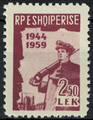 Miner with Jackhammer in front of an Industrial Plant