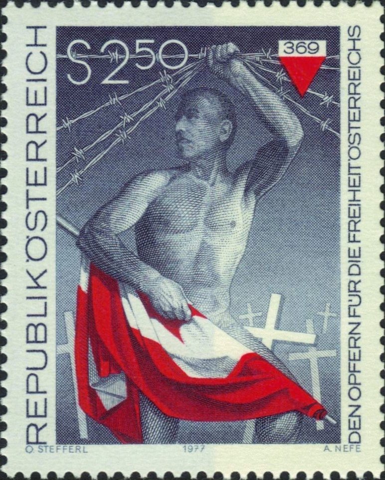 Freedom fighter holding up barbed wire & flag, grave crosses