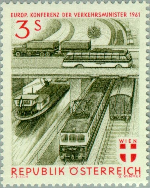 Truck & omnibus on bridge over trains and barges