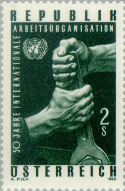 Two fists with spanner, UNO badge