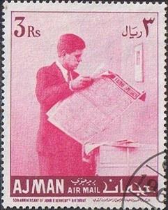 Stamp, Kennedy reading newspaper, Ajman,  