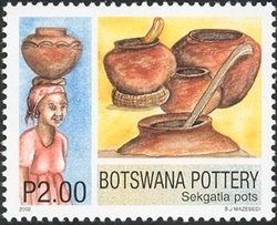 Finished Sekgatla pots & woman carrying water with a pot