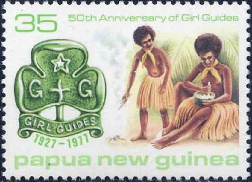 Wearing grass skirts, cooking and green badge