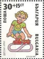 Boy playing with a Model Railway