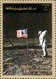 Astronaut in front of flag on the moon