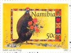 Helmeted Guineafowl (Numida meleagris) - holding Flowers