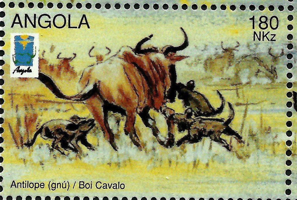 Wildebeest (Connochates sp.) and African Hunting Dogs (Lycao