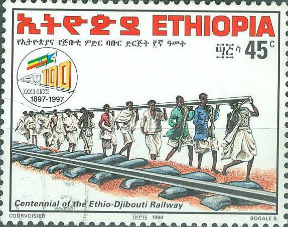Men carrying rails during construction