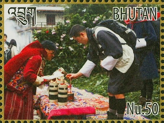 King Jigme and Queen Jetsun looking at items on table