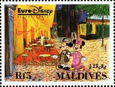 Mickey and Minnie walking by outdoor café