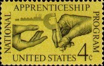 Machinist Handing Micrometer to Apprentice