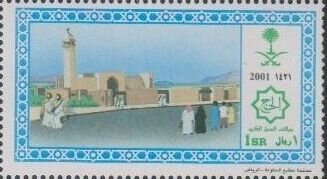 Mosque, tower and two men at left.